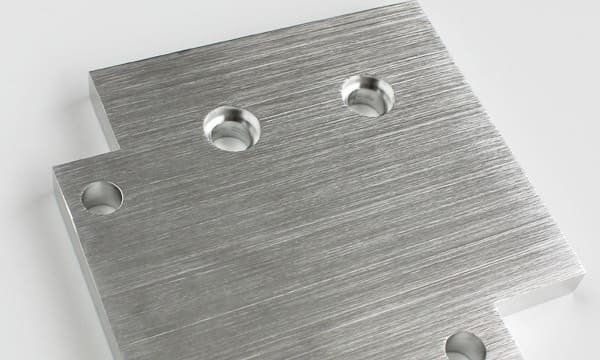 Brushed finish CNC machined metal components with linear surface texture