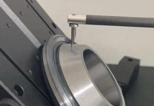 Surface roughness tester measuring Ra value on machined metal surface