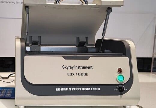 XRF spectrometer analyzer verifying metal alloy composition before CNC machining