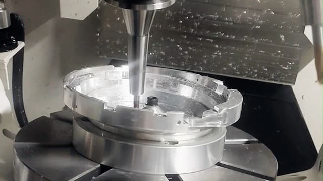 5-axis CNC machining center producing a complex precision metal component